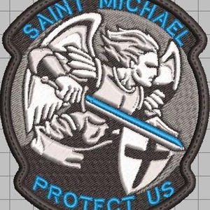 May include: Embroidered patch featuring Saint Michael, depicted with a sword and shield. The patch has a gray background with blue text that reads "SAINT MICHAEL PROTECT US". The design includes white and blue accents.