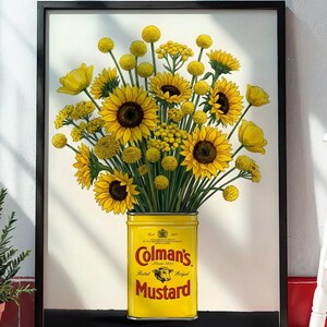 May include: A framed print featuring a bouquet of bright yellow sunflowers and billy ball flowers arranged in a vintage yellow Colman's Mustard tin. The tin displays the red Colman's logo, a bull's head emblem, and the text Mustard, Estd 1814.