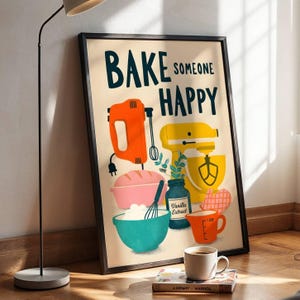 May include: A framed wall art print with a cream background featuring the text BAKE SOMEONE HAPPY in dark blue. The illustration includes an orange hand mixer, a yellow stand mixer, a pink loaf pan, a teal mixing bowl, and a vanilla extract jar.