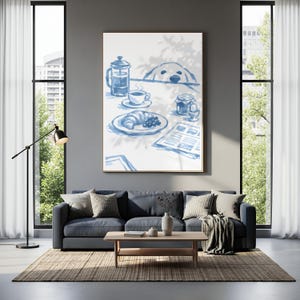 May include: A framed wall art print featuring a blue and white watercolour illustration of a breakfast scene with a French press, a cup of coffee, a croissant, a jam jar, a soft-boiled egg, a newspaper, and a dog peeking over the table edge.