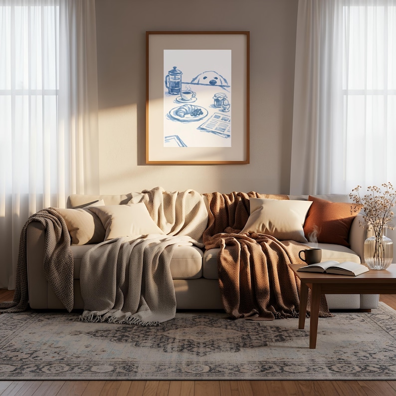 May include: A framed wall art print featuring a blue ink illustration of a breakfast table setting with a French press, a cup of coffee, a croissant, a jar, an egg, and a newspaper, with a dog peeking over the edge of the table.