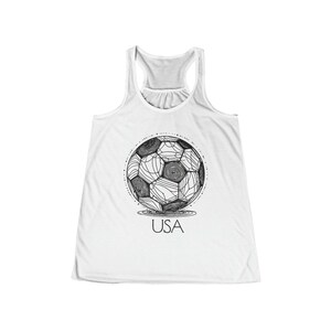 May include: White tank top with a black and white illustration of a soccer ball with the word "USA" underneath.