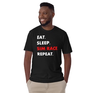 May include: A black t-shirt with white text that reads "Eat. Sleep. Sim Race. Repeat.". The word "Sim Race" is in red.