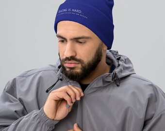 May include: A royal blue beanie with the text "RACING IS HARD..." in white.