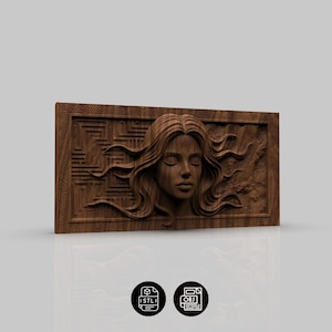 May include: A wooden wall art piece featuring a carved female face with flowing hair and closed eyes. The artwork is framed with geometric patterns and has a natural wood grain finish. The piece is a decorative item.