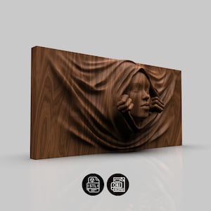 May include: A rectangular wooden wall art piece featuring a carved relief of a woman's face emerging from draped fabric. The artwork is in shades of brown, with visible wood grain. The piece includes STL and OBJ file icons.