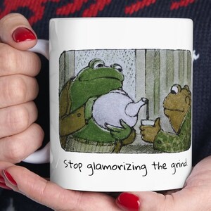 "Frosch und Kröte ""Stop Glamorizing the Grind"" Becher."