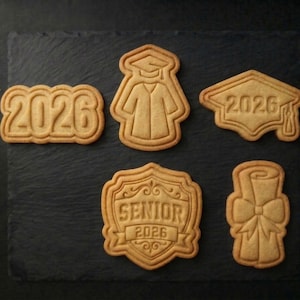 May include: A white ceramic mug with a black handle and the text "But First, Coffee" in a black, bold font. The mug is on a white surface. The mug is approximately 4 inches tall.