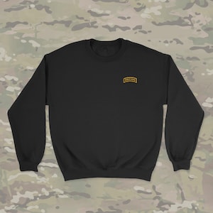 May include: Black long-sleeve sweatshirt with a yellow embroidered patch that says "RECON" on the left chest.