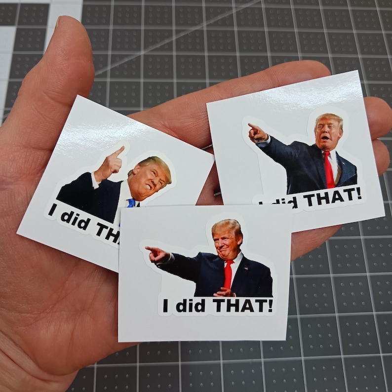 May include: Three white square stickers with a photo of a man in a suit pointing and the text "I did THAT!" on each sticker.