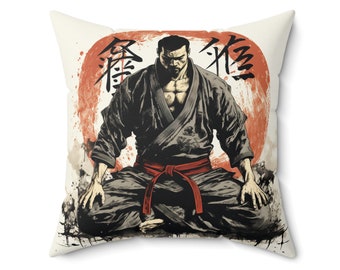 May include: A throw pillow with a white background featuring a black and white illustration of a man in a martial arts pose. The man is wearing a black gi with a red belt. The background includes a red circle with Japanese characters that read "忍術" (Ninjutsu).