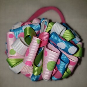 Hair bow. Pink, green, white and blue polka-dots 3 1/2 inch grosgrain ribbon loopy hair bow on pink nylon headband