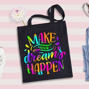 May include: Black tote bag with the text "MAKE YOUR DREAMS HAPPEN" in rainbow colors.