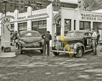 1942. Washington, D.C. Filling up with gas on the day before rationing starts-Photo.