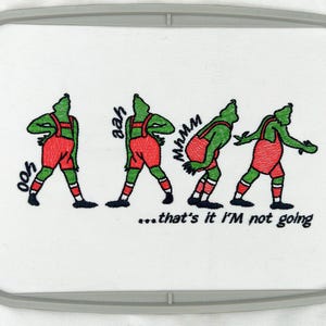 May include: Embroidered design of a green character in various poses with the text "...that's it I'M not going" and the words "ooh", "aah", and "mmmm" written around the character.