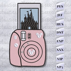 May include: Pink instant camera with a Mickey Mouse silhouette on the front and a picture of a castle inside the viewfinder.