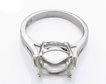 May include: Silver ring setting with a prong setting for an oval shaped gemstone.