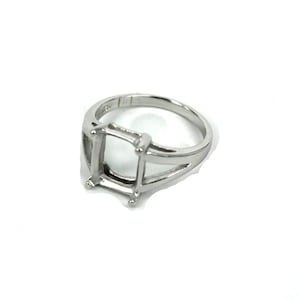 May include: A silver ring with a square setting for a gemstone. The ring has a simple, elegant design.