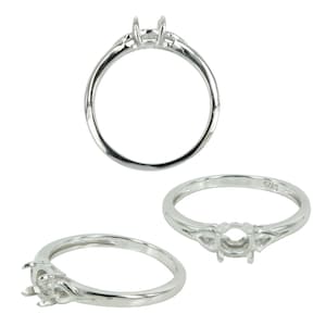 May include: A silver ring setting with a round bezel for a stone. The ring has a Celtic knot design on the band.