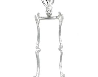 May include: Silver pendant setting with a delicate, ornate design. The setting features a rectangular opening for a stone and is adorned with small, clear cubic zirconia stones.