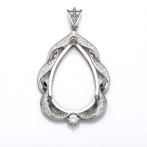 May include: Silver pendant with a teardrop-shaped opening for a gemstone. The pendant is decorated with small, clear stones around the edge and has a bail at the top for attaching a chain.