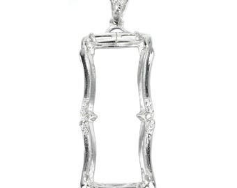 May include: Silver pendant with a rectangular frame and small clear stones. The frame is open and can be used to hold a photo or other small object.