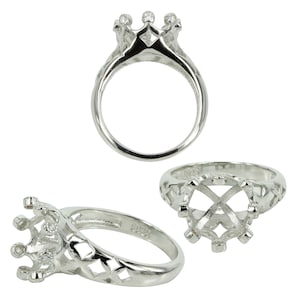 May include: Silver ring setting with a crown-shaped design and a round center for a gemstone. The ring is made of sterling silver and has a 925 hallmark.