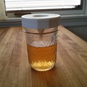 a jar of honey sitting on a wooden table