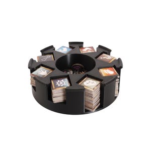 May include: A black, circular game card organizer with multiple compartments. Each compartment holds stacks of game cards with various colorful icons. The center holds game tokens. The organizer is designed to keep game components organized.