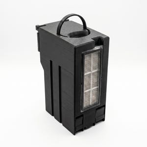 May include: A black rectangular device with a handle on top and a clear, rectangular filter. The device has a textured surface and appears to be made of plastic. The filter has a grid-like pattern.