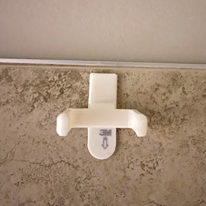 a white toilet paper dispenser mounted to a wall