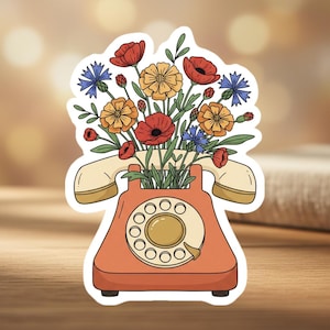 May include: A white ceramic mug with a black handle and the text "But First, Coffee" in a black, bold font. The mug is sitting on a white surface. The mug is approximately 4 inches tall.