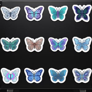 May include: A collection of twelve butterfly stickers in various colors and designs. The stickers feature shades of blue, purple, green, and brown. Some butterflies have circuit board-like patterns, while others have gradient color schemes. Each sticker has a white border.
