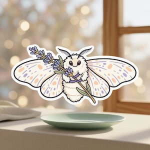 May include: A sticker featuring a cartoon moth holding a sprig of lavender. The moth has white fur, large wings with orange and purple spots, and a black outline. The lavender is purple and green. The sticker is on a white background.