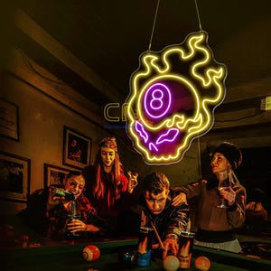May include: A neon sign shaped like a flaming eight ball with a purple center and yellow flames. The sign features the number eight in white and is suspended by wires. The design is outlined in bright yellow neon tubing.