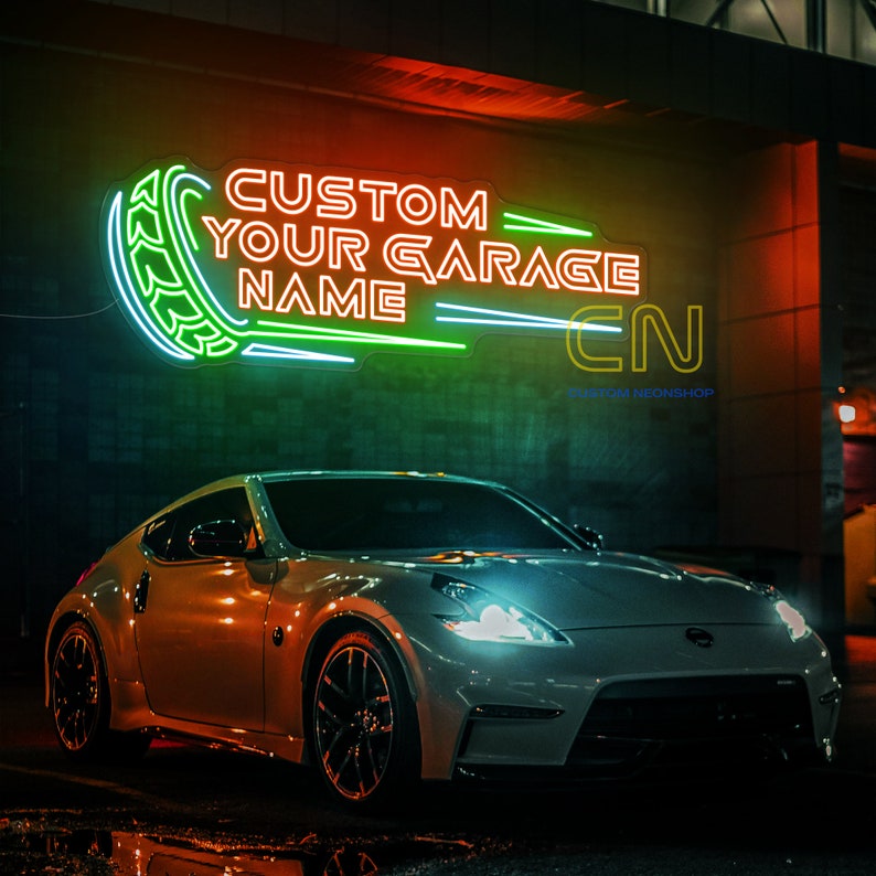 May include: A white sports car parked in front of a building with a neon sign that reads "Custom Your Garage Name CN Custom Neonshop".
