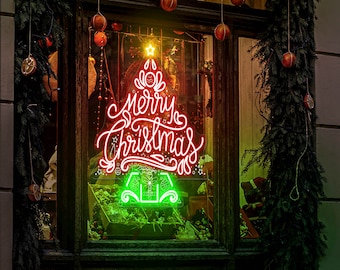 May include: A red neon sign in the shape of a Christmas tree with the words "Merry Christmas" in a cursive font. The sign is in a window with a green garland and red ornaments hanging around it.
