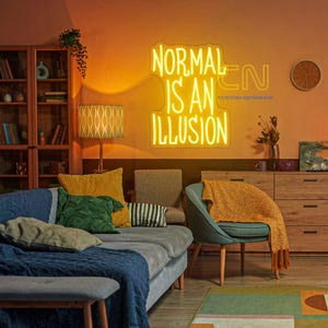 May include: A neon sign with the words "NORMAL IS AN ILLUSION" in yellow, mounted on an orange wall. The sign is in a living room setting with a sofa, chairs, and wooden furniture. The room is decorated with pillows, a rug, and a lamp.