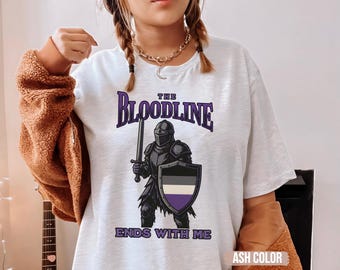 May include: White t-shirt with a purple and black knight graphic and the text "The Bloodline Ends With Me".