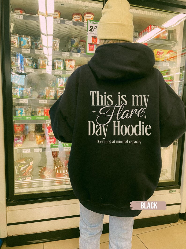 May include: A black hoodie with the text "This is my Flare Day Hoodie" in white script. The hoodie also has the text "Operating at minimal capacity." The word "BLACK" is at the bottom of the image.