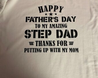 May include: White t-shirt with black text that reads "Happy Father's Day to my amazing Step Dad = Thanks for = Putting up with my Mom".