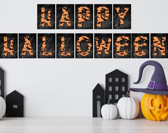 May include: A Halloween-themed display featuring the words "HAPPY HALLOWEEN" in orange letters with bat and polka dot patterns against a black background. Decorative pumpkins, a witch's hat, and black house cutouts complete the festive scene.