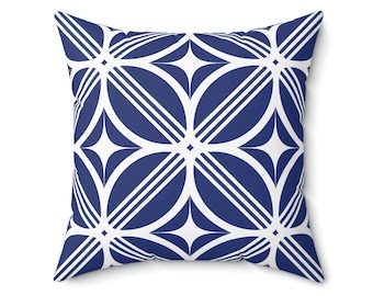 Puede incluir: Cojín cuadrado con un patrón geométrico en azul marino y blanco. El diseño presenta un patrón repetitivo de formas florales estilizadas y rayas diagonales. El cojín es cuadrado y está hecho de una tela suave.