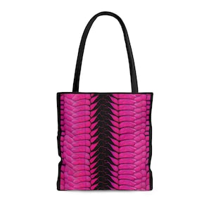 May include: A pink tote bag with a black and pink scale pattern. The bag has black straps.