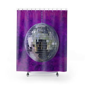 May include: A silver disco ball hangs from a chain against a purple background with a textured, marbled effect.