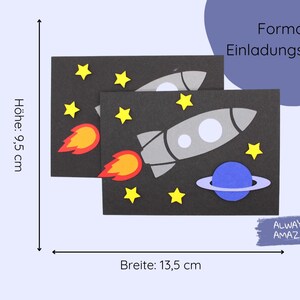 May include: A black cardstock invitation with a rocket ship, planet, and stars. The card is 9.5 inches tall and 13.5 inches wide. The text on the card reads "Format Einladungskarte" and "Always Amazing".