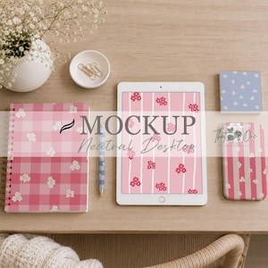 May include: A mockup of a neutral desktop scene featuring a pink and white floral patterned notebook, tablet, and phone case. The tablet displays a matching floral design. A pen, small bowl with paperclips, and a vase with flowers are also present.