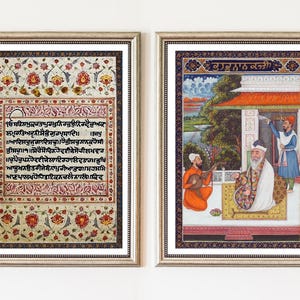 May include: Two framed rectangular prints featuring intricate artwork. The left print displays dense Gurmukhi script surrounded by a floral border. The right print depicts a scene with three figures, including one playing a stringed instrument.