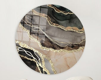 Puede incluir: Arte de pared redondo con un diseño abstracto en espiral en tonos marrones, negros y dorados. El diseño se asemeja al ágata o al mármol con acentos dorados.