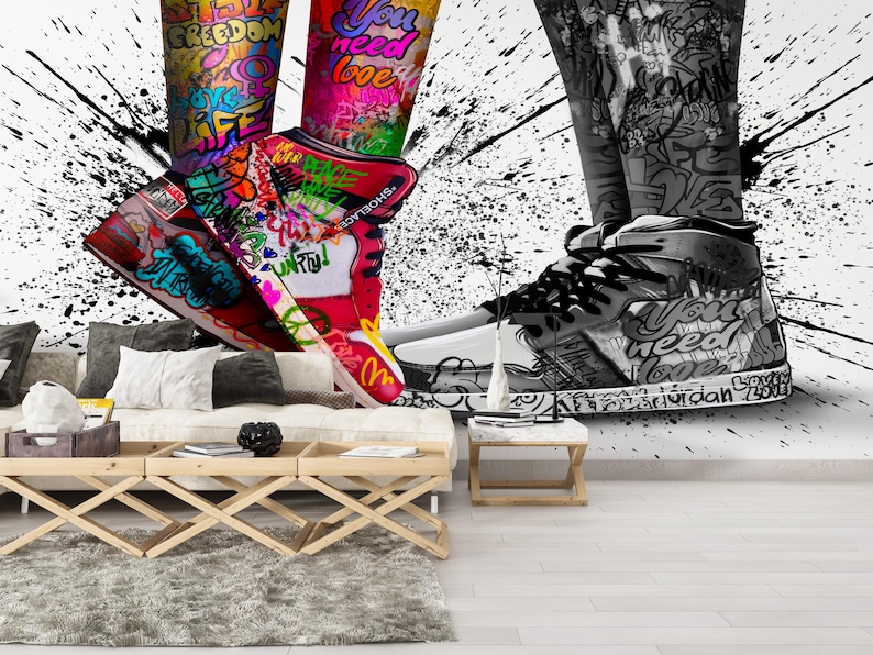 May include: A pair of sneakers with colorful graffiti designs, including the words "freedom", "you need love", and "Air Jordan 720". The sneakers are on a white background with black splatters.